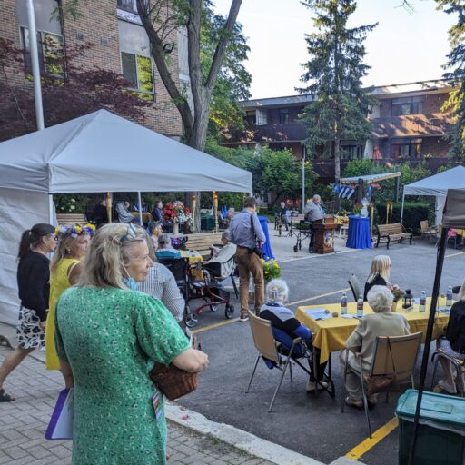 Group of people enjoying a barbecue with community members